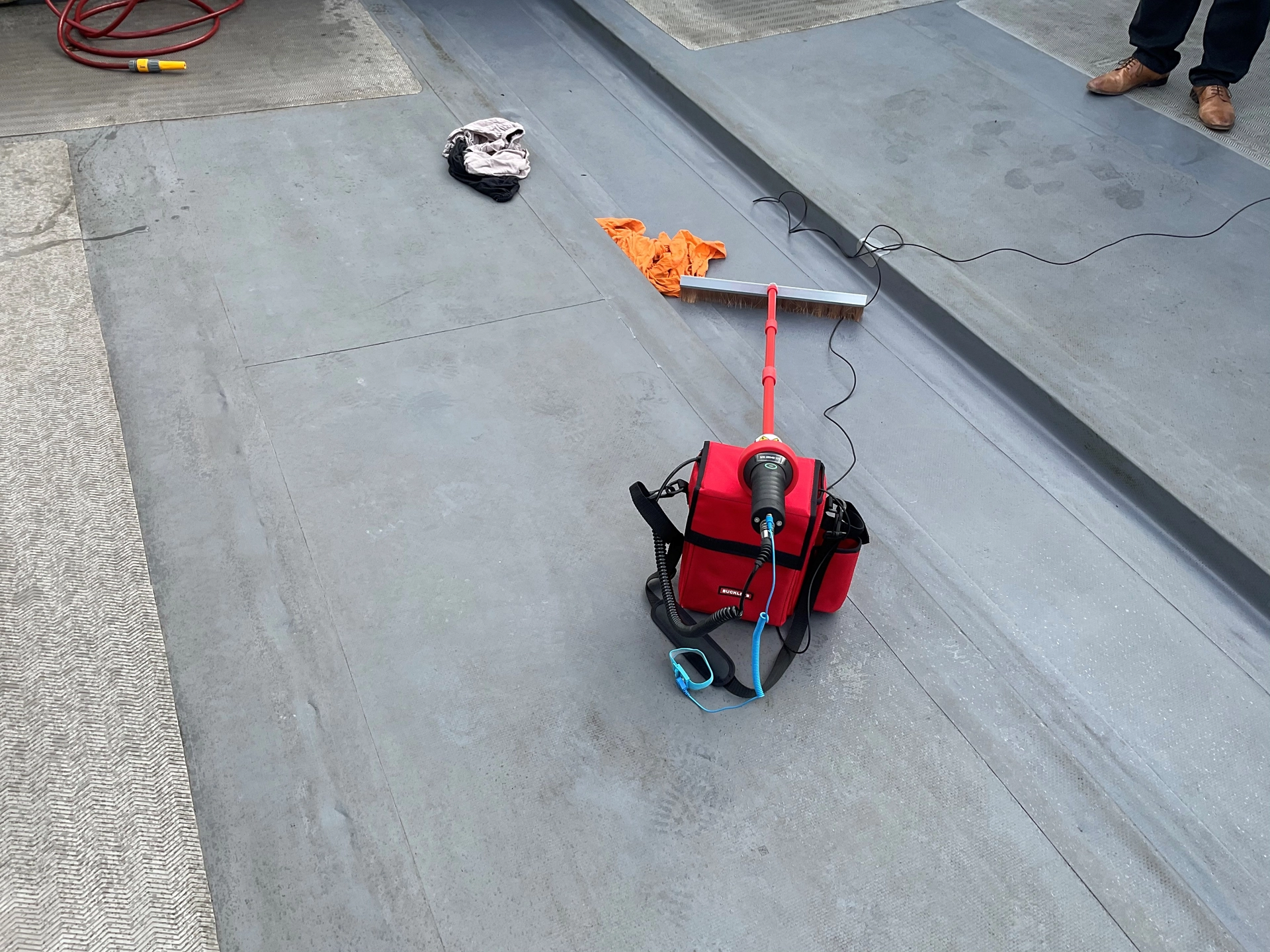 Engineer using diagnostic tools to locate roofing leaks